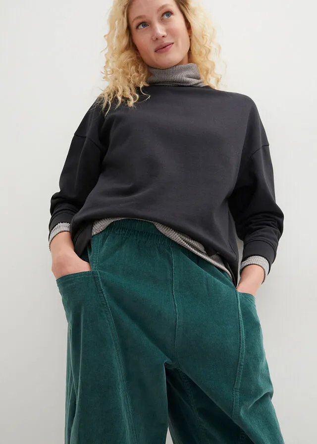 Cómodo pantalón de pana con amplios bolsillos y cintura cómoda verde mate